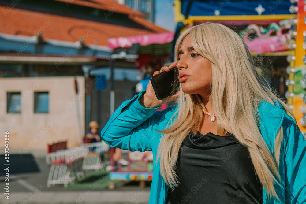 Fototapeta premium girl with mobile phone in amusement park or fair