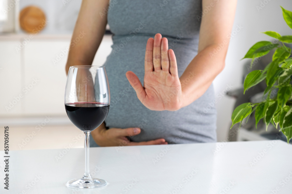 Φωτογραφία Pregnant woman show NO gesture to glass of wine