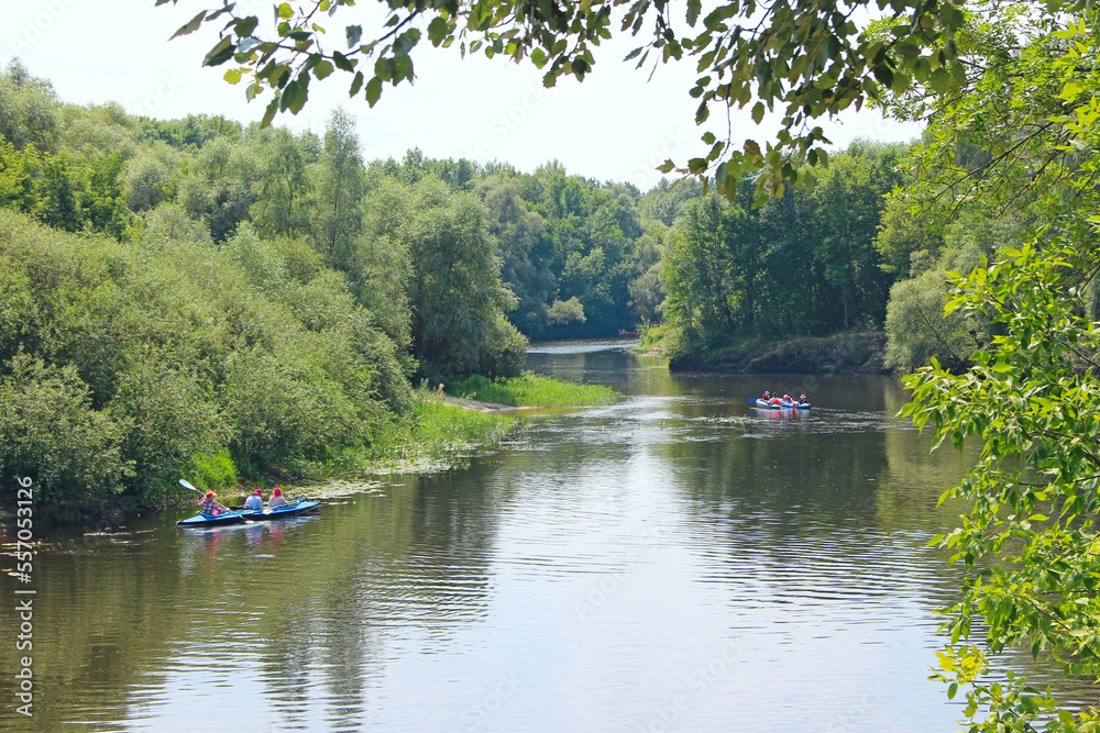 group of people are sailing on kayaks along a beautiful river
