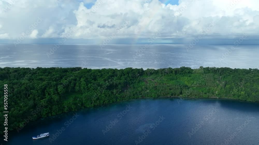 A faint rainbow appears behind a remote tropical island in the Solomon Islands. This beautiful country is home to spectacular marine biodiversity and many historic WWII sites. A faint rainbow appears behind a remote tropical island in the Solomon Islands. This beautiful country is home to spectacular marine biodiversity and many historic WWII sites.