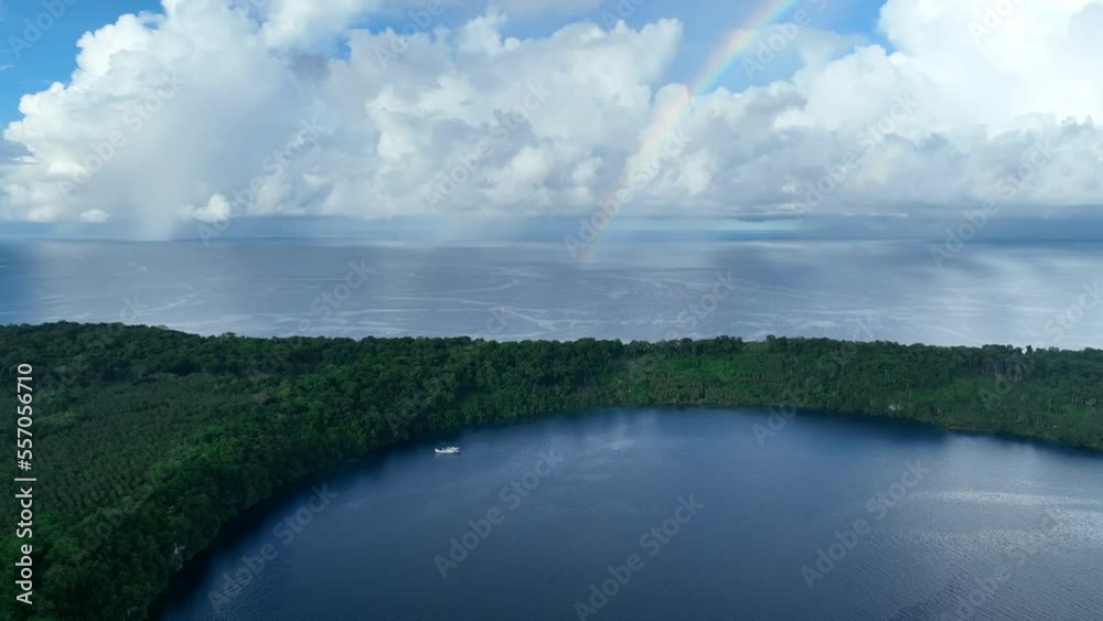 A faint rainbow appears behind a remote tropical island in the Solomon Islands. This beautiful country is home to spectacular marine biodiversity and many historic WWII sites. A faint rainbow appears behind a remote tropical island in the Solomon Islands. This beautiful country is home to spectacular marine biodiversity and many historic WWII sites.