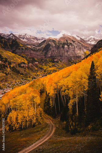 View from a gondola of tall aspen trees and striking mountain landscape views in Telluride, Colorado in the fall