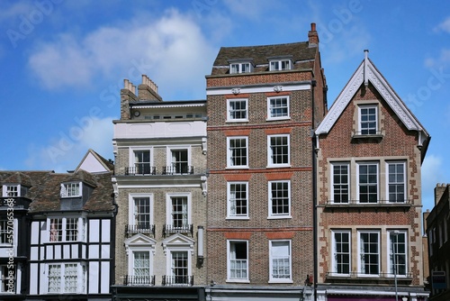 Row of tall, narrow old buildings with apartments on top and stores below, Cambridge, England