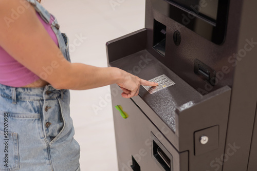 Faceless woman dialing bank card pin at ATM. 
