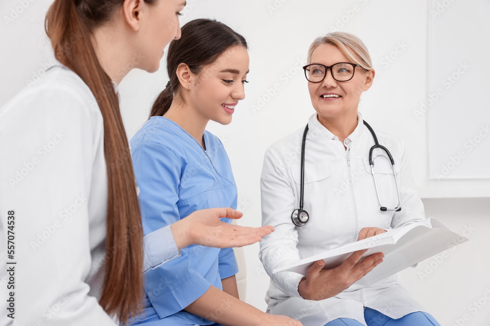 Team of professional doctors having discussion in clinic Team of professional doctors having discussion in clinic