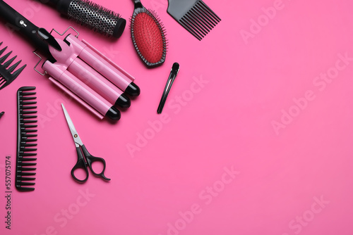 Fototapeta Naklejka Na Ścianę i Meble -  Flat lay composition of professional hairdresser tools on pink background, space for text