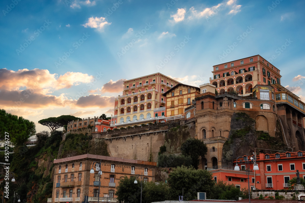 Homes and Hotels in a touristic town on the seafront. Sorrento, Compania, Italy. Colorful Sunrise Sky Art Render.