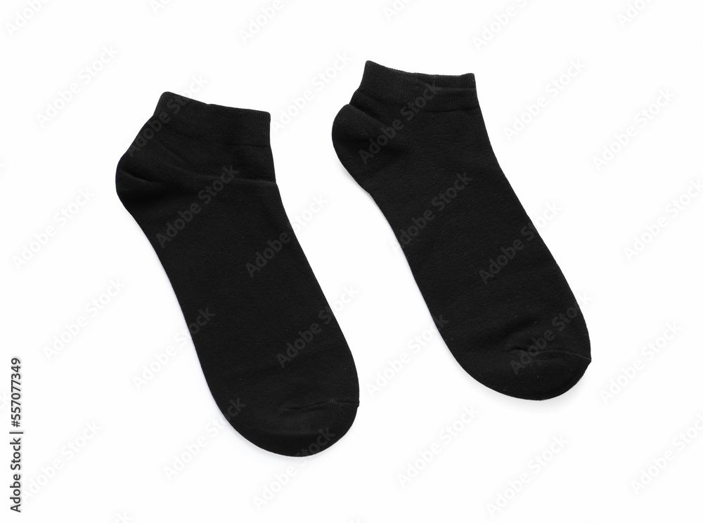 Pair of black socks on white background, top view