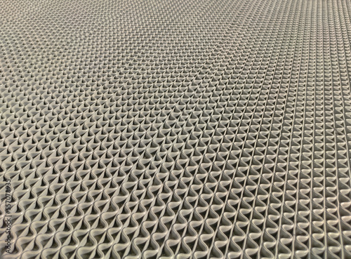Pattern background of grey rubber foot mat wavy design texture or real object at home or building