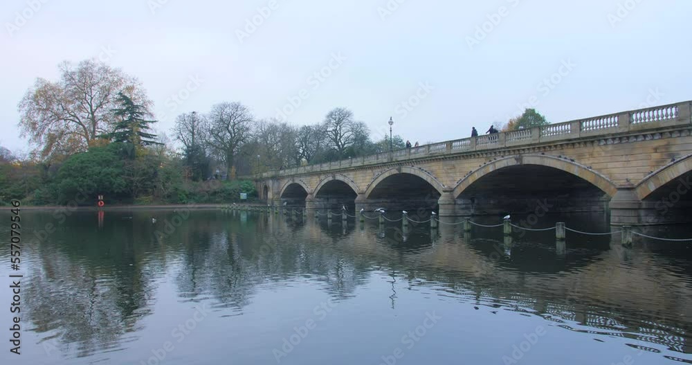 Serpentine Bridge Over The Calm Waters In Hyde Park, London, England. - panning Serpentine Bridge Over The Calm Waters In Hyde Park, London, England. - panning