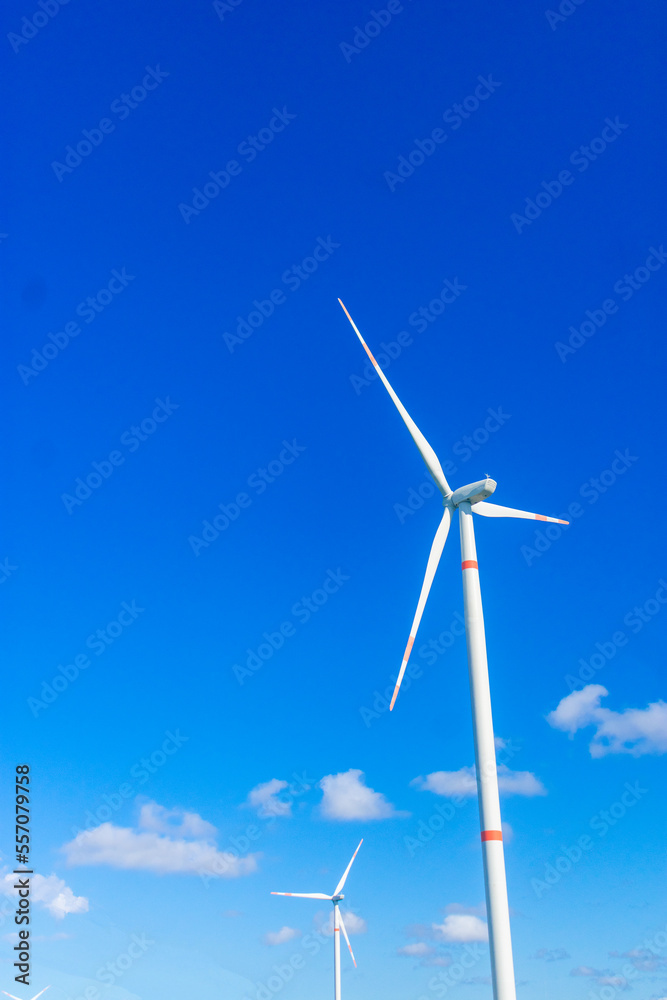 two windmills with a blue sky at the south east coast. Concept of renewable energy