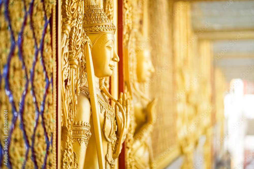 Gold door angel sculpture is a high relief art and is made of resin at the Golden Castle, Tha Sung Temple, Uthai Thani