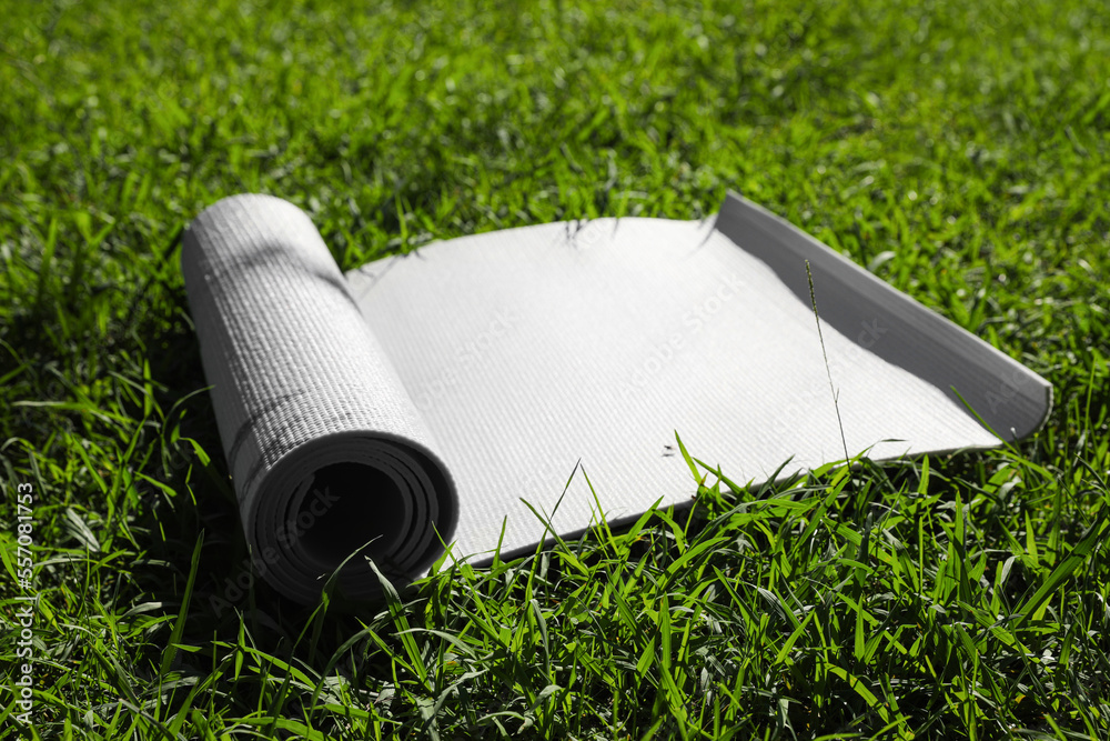 Karemat or fitness mat on green grass outdoors Karemat or fitness mat on green grass outdoors