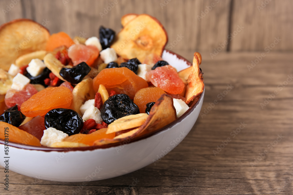 Bowl with different tasty dried fruits on wooden table, closeup. Space for text Bowl with different tasty dried fruits on wooden table, closeup. Space for text