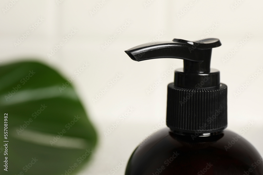 Shampoo bottle on blurred background, closeup. Space for text Shampoo bottle on blurred background, closeup. Space for text