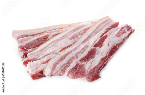 Slices of tasty pork fatback with spices on white background