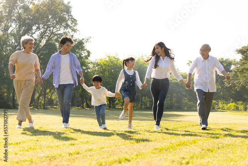 Happy Asian family running in the park, Outdoor with big family and summer season concept