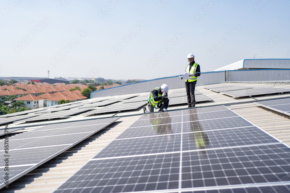 custom made wallpaper toronto digitalEngineer on rooftop kneeling next to solar panels photo voltaic with tool in hand for installation