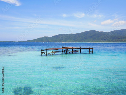 Paradise beach with pier and mountains
