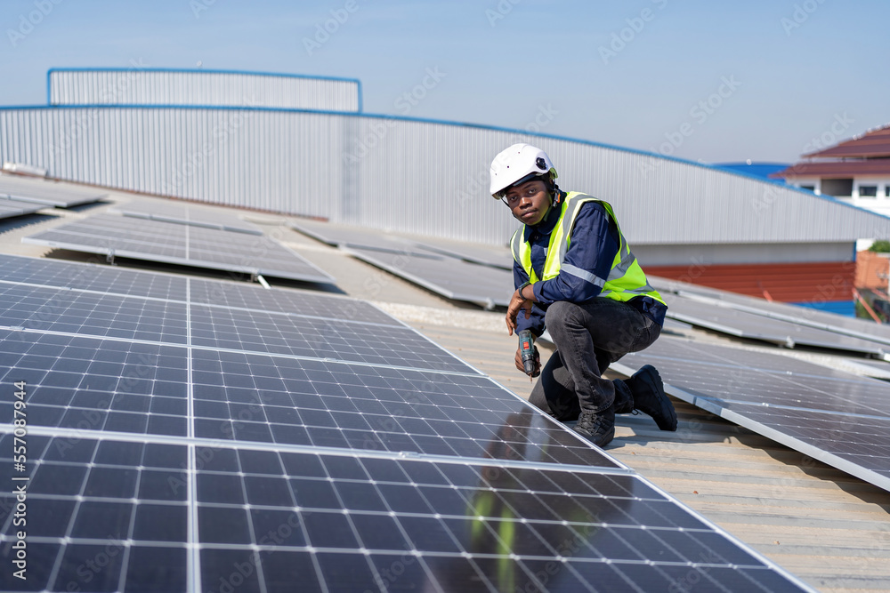 custom made wallpaper toronto digitalEngineer on rooftop kneeling next to solar panels photo voltaic with tool in hand for installation