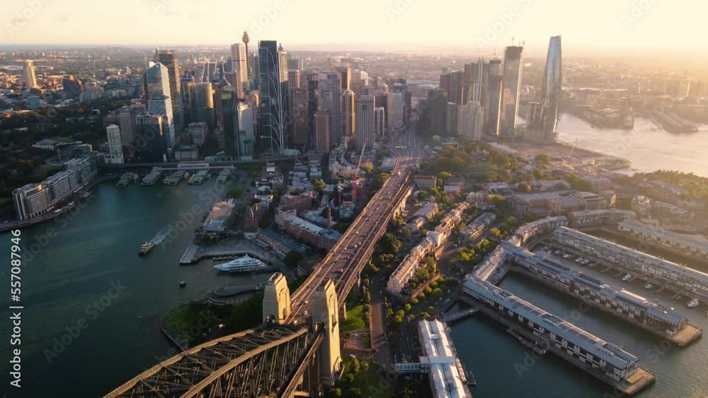 Aerial drone pullback reverse view of Sydney City and Sydney Harbour above Sydney Harbour Bridge in the late afternoon  