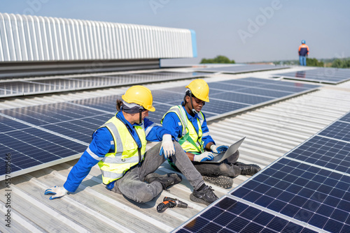 Wallpaper Mural Engineer on rooftop sitting next to solar panels photo voltaic check laptop for installation
 Torontodigital.ca