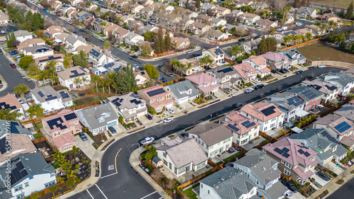 Top Down aerial photos over a community in California with homes with solar panels and roadways and parks