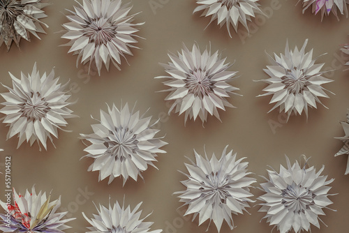 Paper flowers and origami snowflakes from old newspapers close-up view from above. DIY from waste paper. Environmental protection. We teach children make crafts from waste. Recycling of old paper