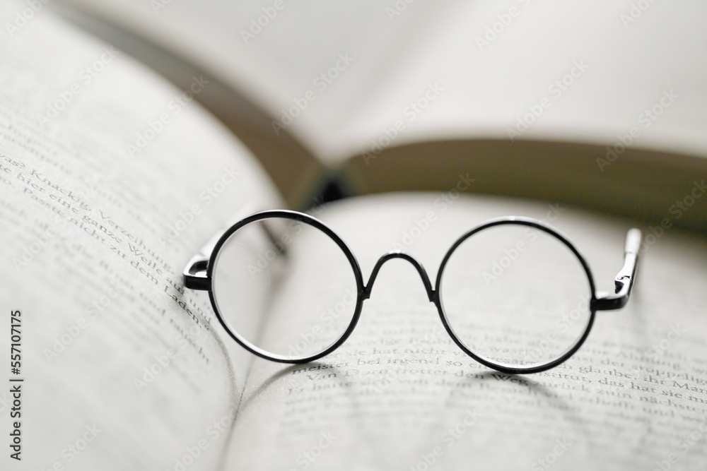 Reading concept.Education and schooling concept.Reading glasses close-up on the pages of a book .Symbol of study, knowledge and reading. Reading concept.Education and schooling concept.Reading glasses close-up on the pages of a book .Symbol of study, knowledge and reading.