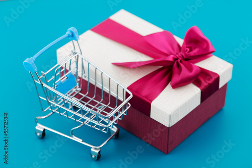 Gift shopping cart on blue