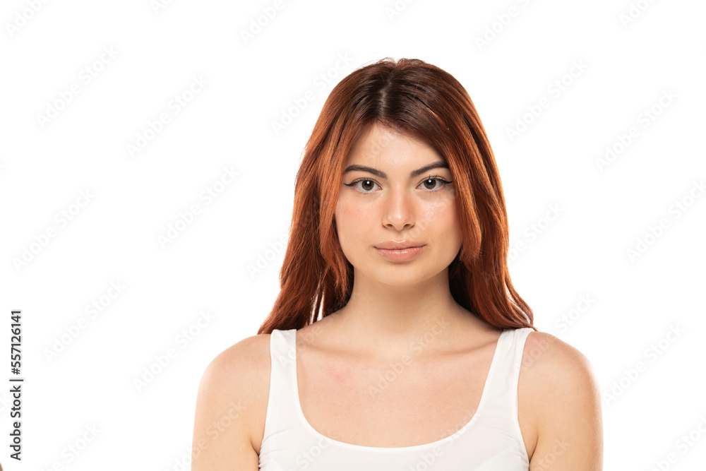 Portrait of serious beautiful woman with long straight ginger hair on a white background Portrait of serious beautiful woman with long straight ginger hair on a white background