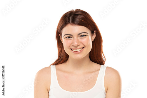 Portrait of smiling beautiful woman with long straight ginger hair on a white background