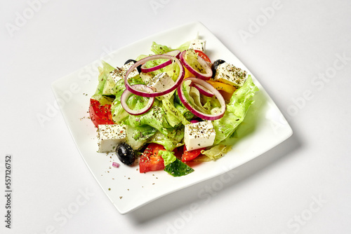 greek salad in a white plate on a white background