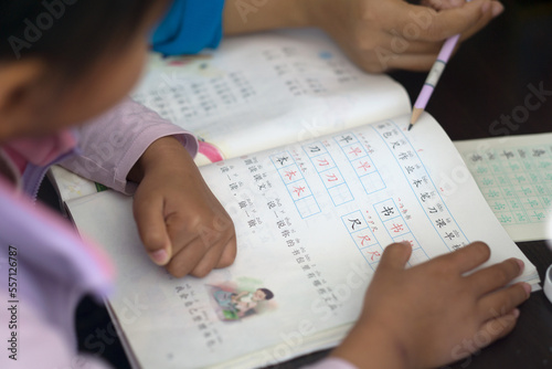 A little girl reading and studying