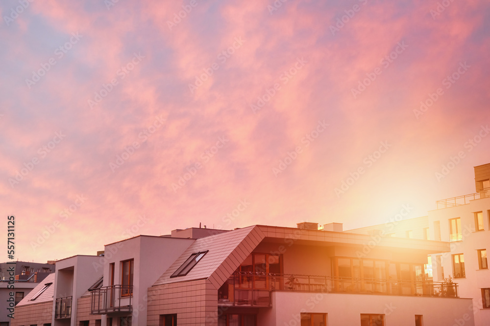 Concept of modern architecture for a better living. Contemporary medium-sized flat building in Europe. Sunset in a European middle house apartment Concept of modern architecture for a better living. Contemporary medium-sized flat building in Europe. Sunset in a European middle house apartment