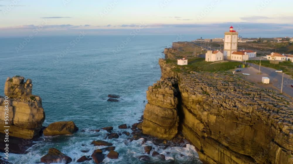Coastal lighthouse. Aerial towards Waves crash over rocks aerial over island with lighthouse. Aerial fly over coastal lighthouse with waves crashing on the cliffside. Portugal. Coastal lighthouse. Aerial towards Waves crash over rocks aerial over island with lighthouse. Aerial fly over coastal lighthouse with waves crashing on the cliffside. Portugal.