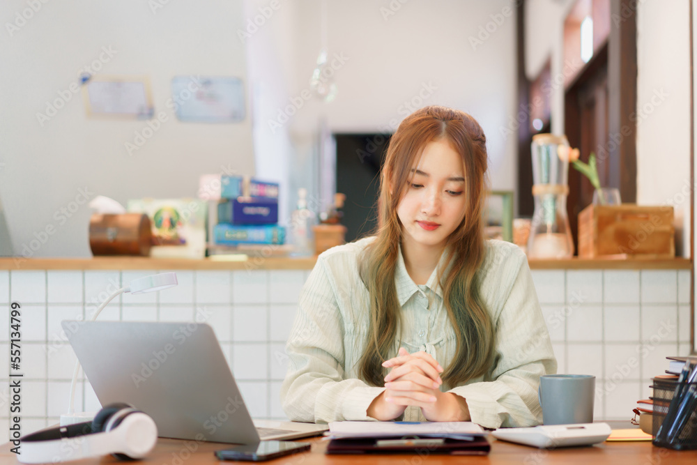 Business concept, Woman entrepreneur reading document and drinking coffee in coworking space office Business concept, Woman entrepreneur reading document and drinking coffee in coworking space office