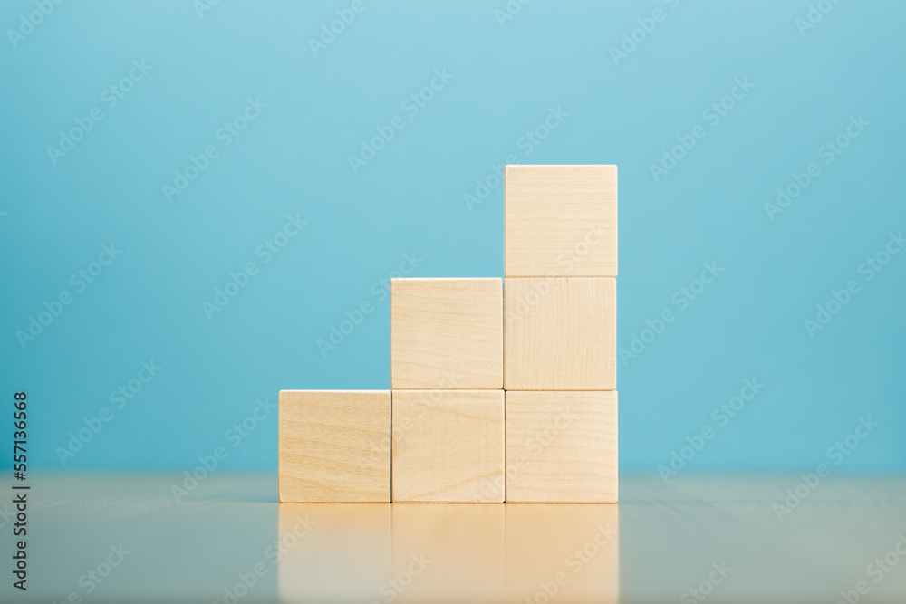 Pyramid of empty wooden blocks on table blue background. Stock Photo ...