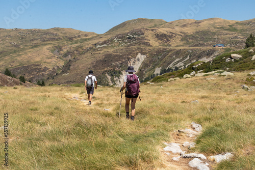 Male and female hikers walking in the mountains  © Julien