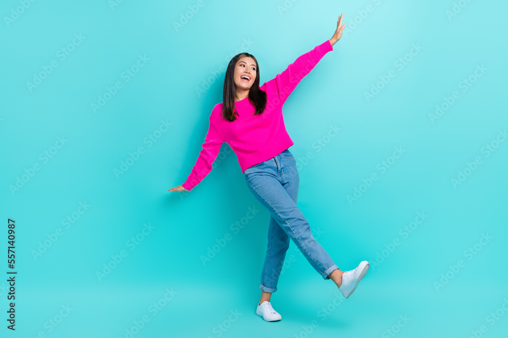 Full length photo of dreamy adorable girl dressed pink pullover walking having fun isolated teal color background