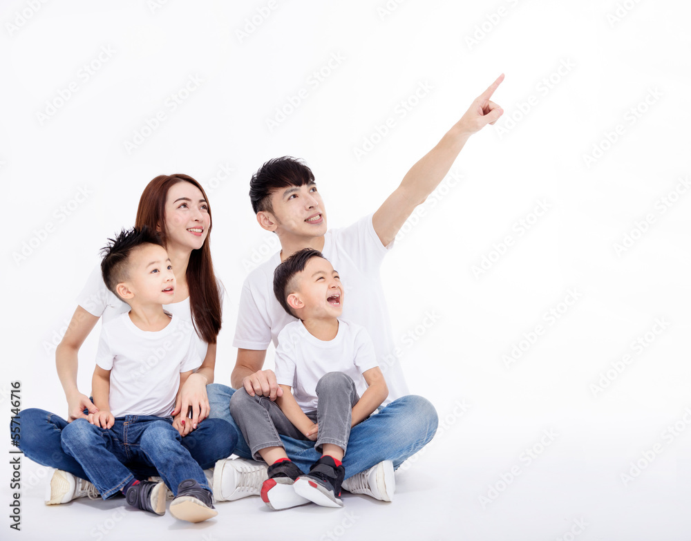 Happy Asian family  sitting on white floor and looking up
