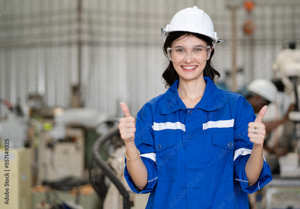 Portrait of smiling female industrial engineer wearing white safety helmet happy work in factory facility. Young beautiful woman manager with confidence working in manufacturing business. copy space. Portrait of smiling female industrial engineer wearing white safety helmet happy work in factory facility. Young beautiful woman manager with confidence working in manufacturing business. copy space.