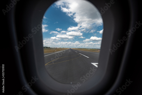Airplane Window and landing and take off road.