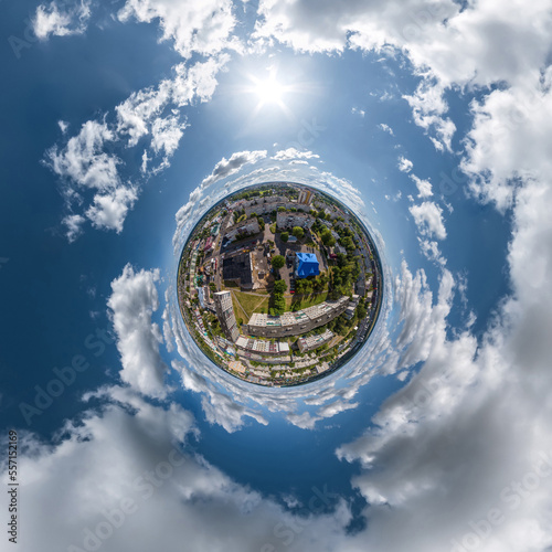 tiny planet in sky with clouds overlooking old town  urban development  historic buildings and crossroads. Transformation of spherical 360 panorama in abstract aerial view.