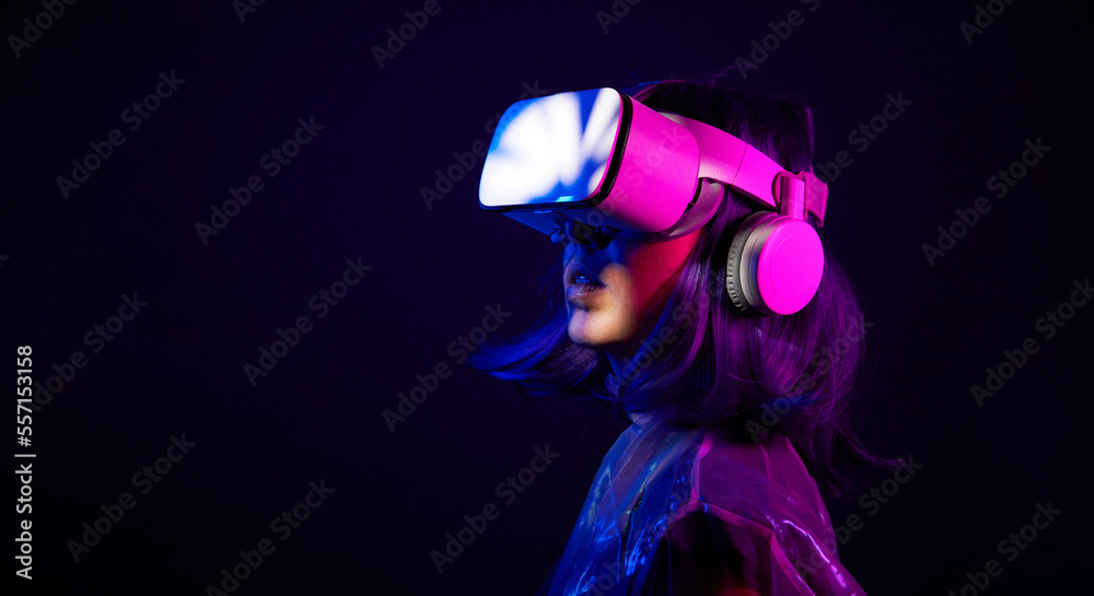 Woman in virtual reality goggle in neon colors.