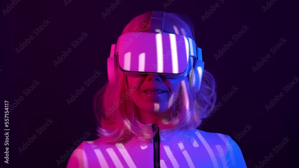 Woman in virtual reality goggle in neon colors.