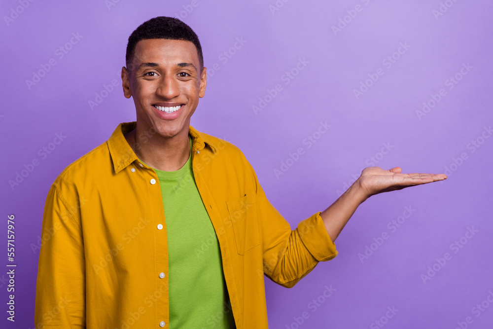 Photo of toothy beaming cheerful optimistic nice guy dressed yellow shirt palm demonstrate product isolated on pastel color background Photo of toothy beaming cheerful optimistic nice guy dressed yellow shirt palm demonstrate product isolated on pastel color background