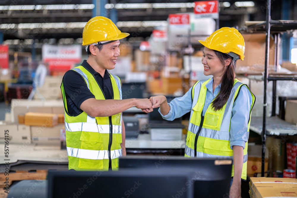 Trainee worker in large depot storage warehouse appreciated thank you to trainer at cashier counter Trainee worker in large depot storage warehouse appreciated thank you to trainer at cashier counter