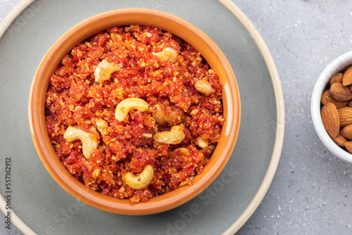 Gajar ka halwa is, Popular Indian dessert pudding made with grated carrots, milk, sugar and nuts served hot with a garnish of almonds, cashew nuts and pistachios.
