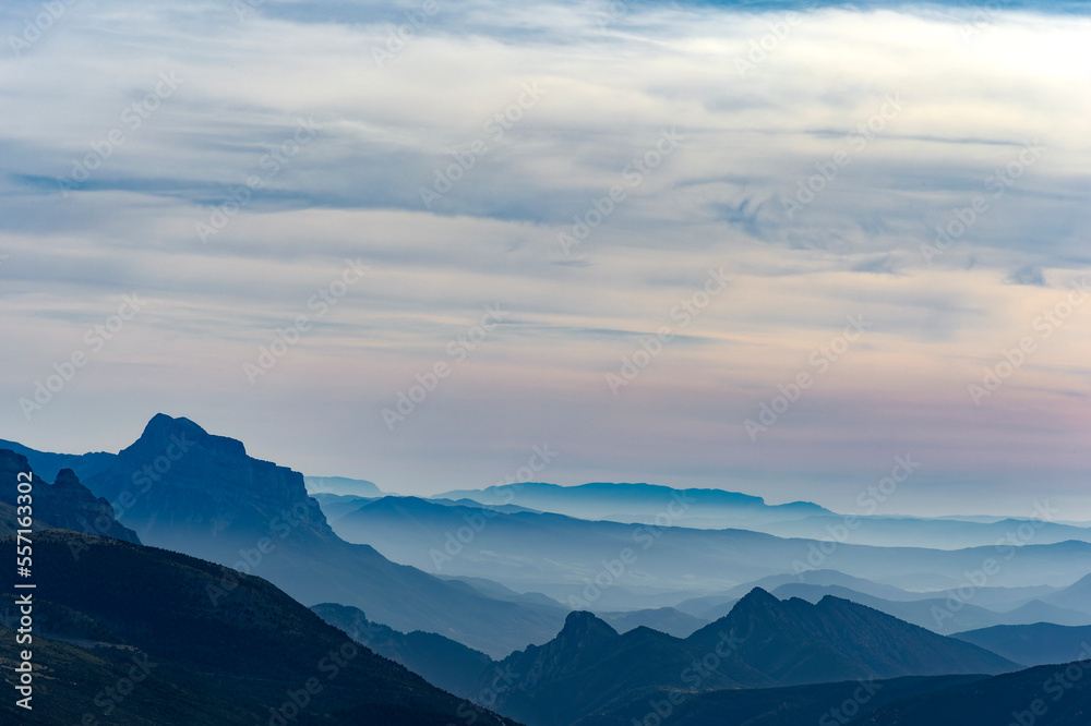 Foggy landscape with the Pyrenees mountains (Spain) in the background during sunrise.